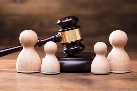 Wooden family next to gavel